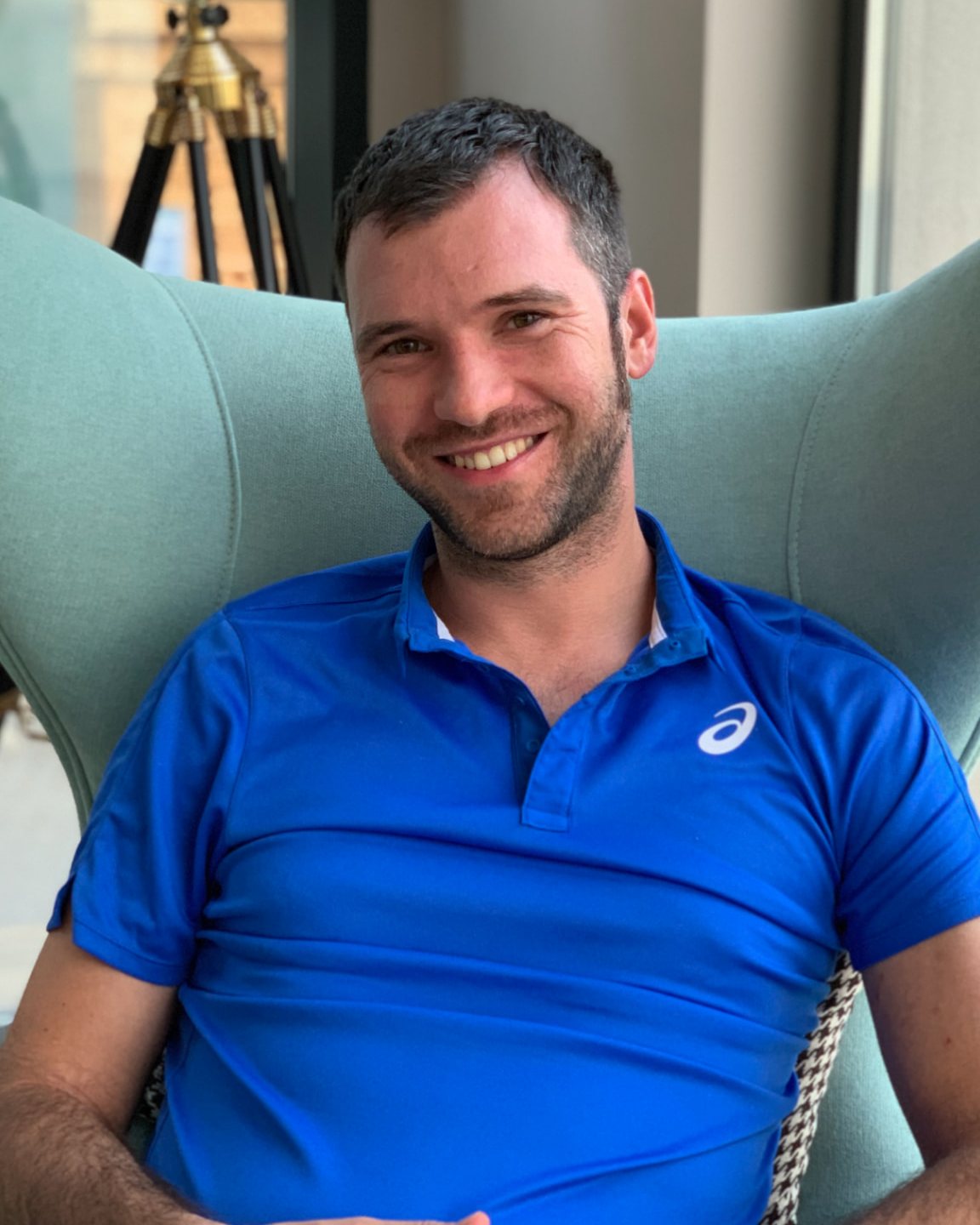 Alex Andreev, smiling in a light blue polo shirt